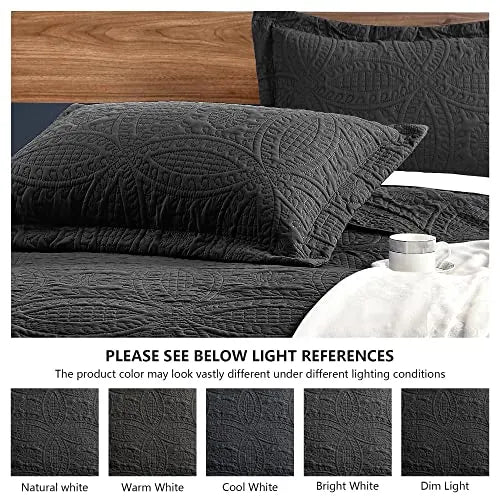 Dark gray textured bedspread on a bed with pillows, surrounded by light references for color accuracy.