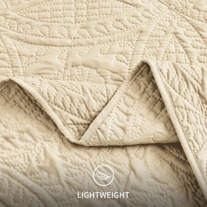 Beige quilted blanket with 'Lightweight' label