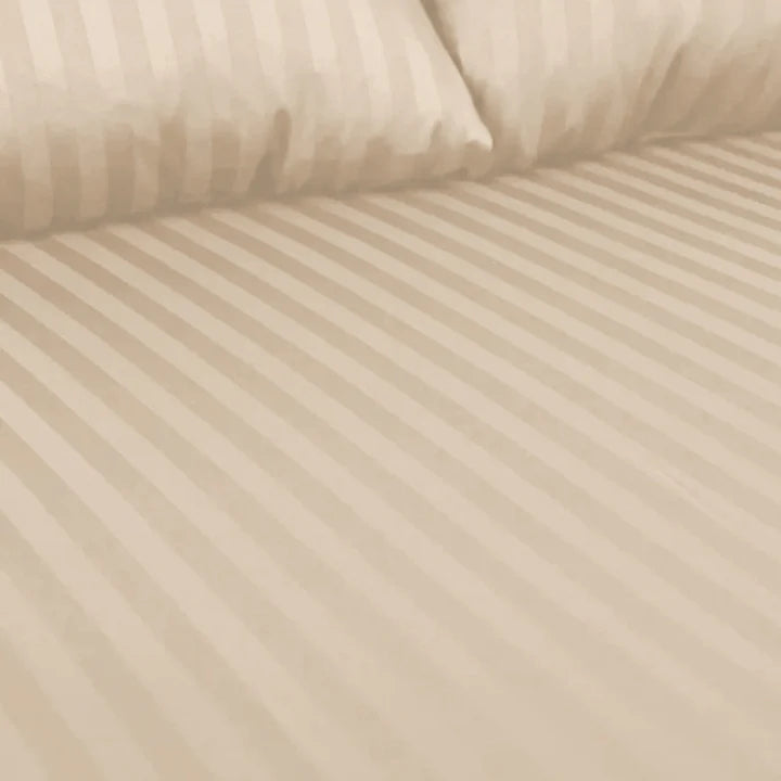 Beige striped fabric with two pillows on top