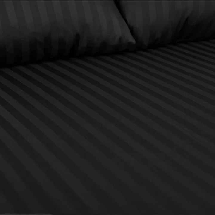 Black striped bed sheet and pillowcase set on a bed.