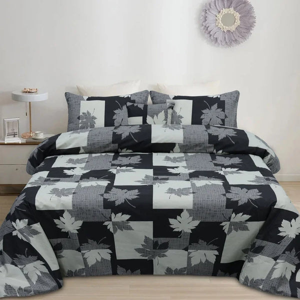 Bedding set with leaf pattern on a bed in a bedroom setting.