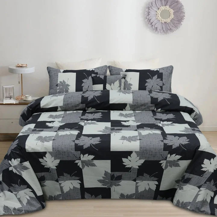 Bedding set with leaf pattern on a bed in a bedroom setting.