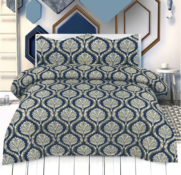 Navy and gold patterned comforter set on a bed with decorative wall art in the background.