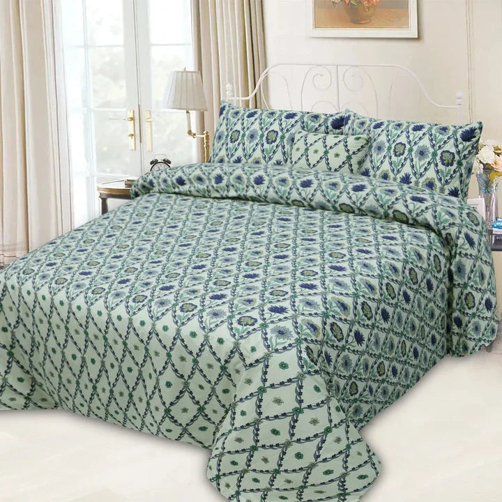 Bed with green patterned bedding in a well-lit bedroom
