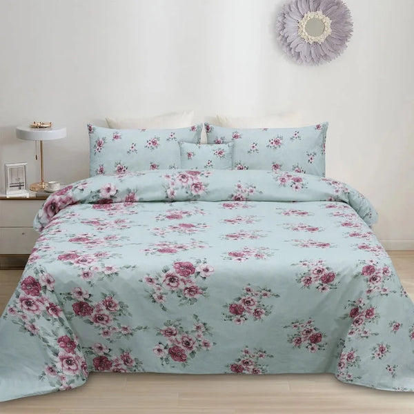 Floral bedding set on a bed in a bedroom with a side table and decorative mirror.