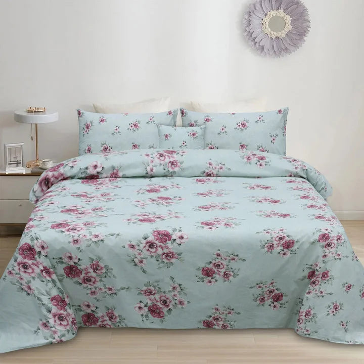 Floral bedding set on a bed in a bedroom with a side table and decorative mirror.