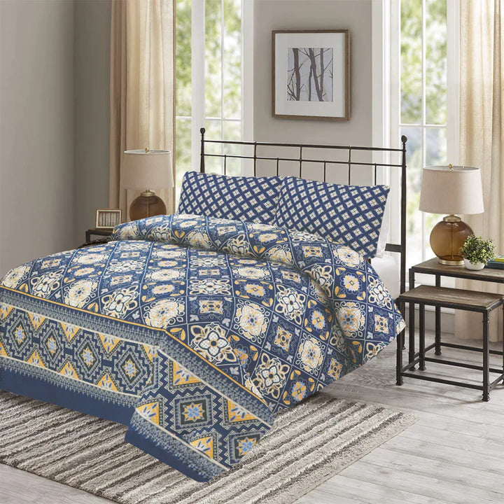Blue and white patterned bedding set on a bed in a bedroom with windows and lamps.