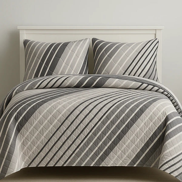 Striped bedding set on a bed with a neutral background