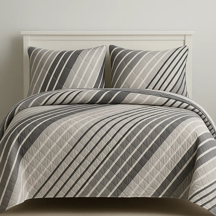 Striped bedding set on a bed with a neutral background