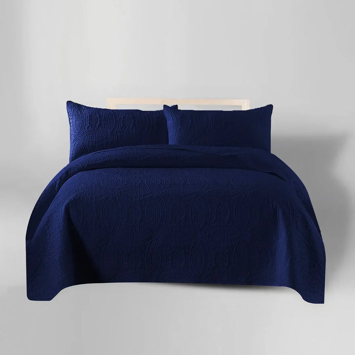 Navy blue bedding set with two pillows on a light gray background