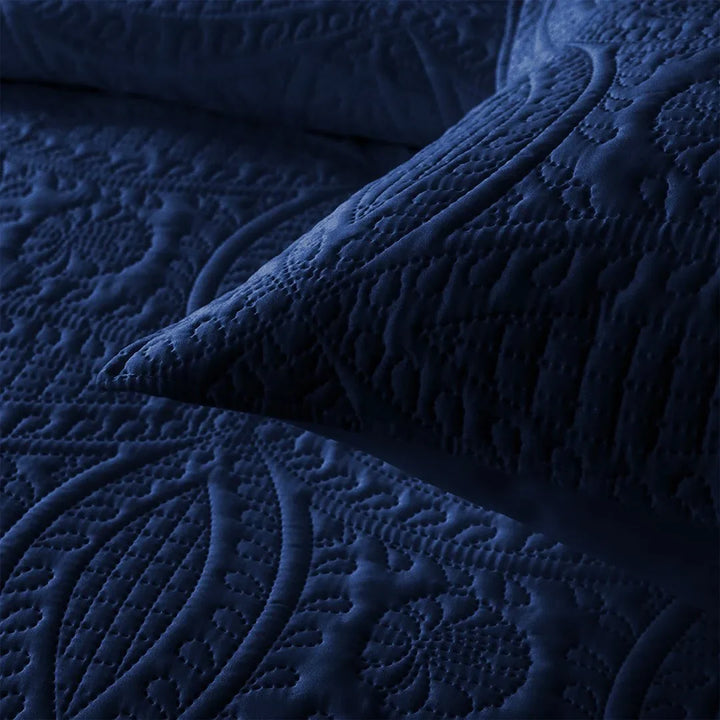 Close-up of textured navy blue fabric with intricate patterns