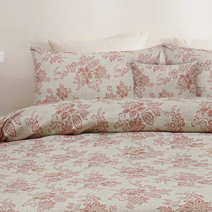 Floral patterned bedding set on a bed with a white background