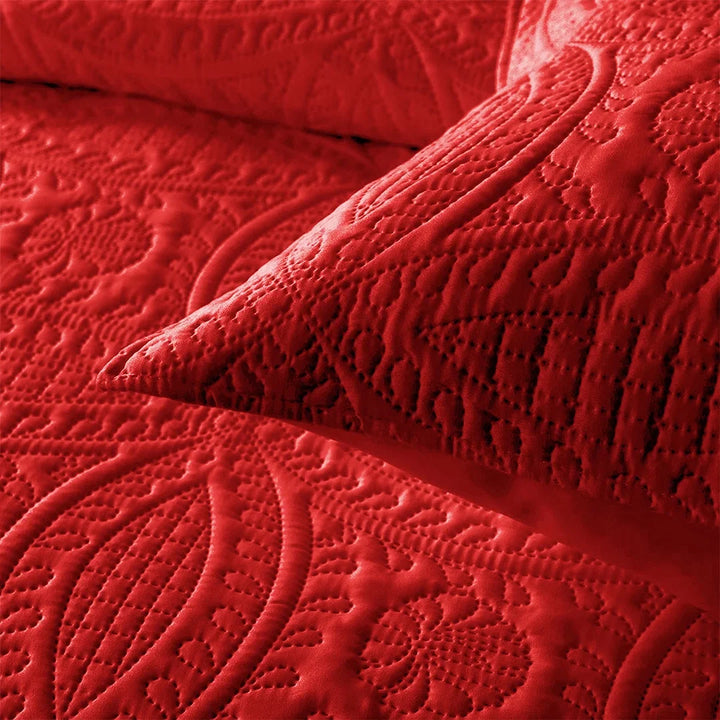 Close-up of a red textured blanket with intricate patterns