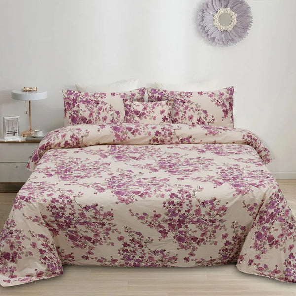 Floral bedding set on a bed in a bedroom with a side table and decorative mirror.
