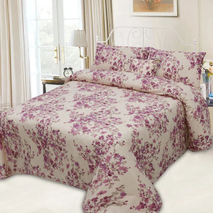 Floral patterned bedding set on a bed in a well-lit bedroom.