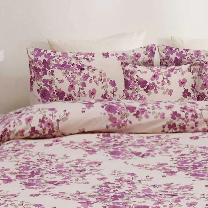Floral bedding set with pink and purple flowers on a white background