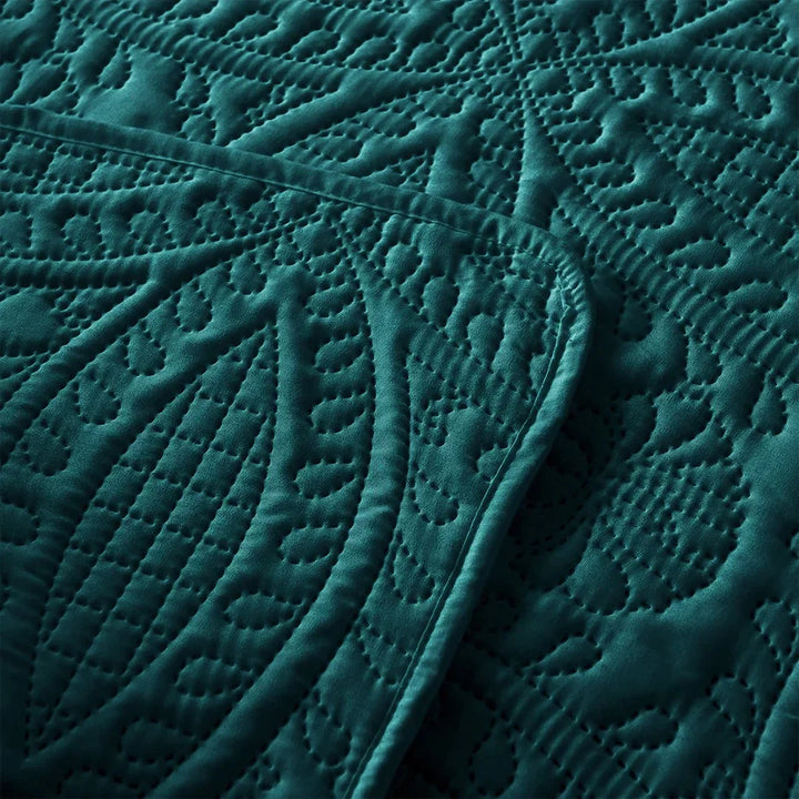 Close-up of textured teal fabric with intricate patterns