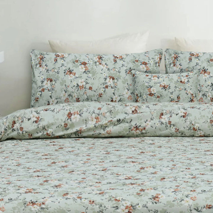 Floral patterned bedding set on a bed with a light background