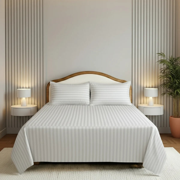 Bedroom with a neatly made bed, nightstands, and lamps.